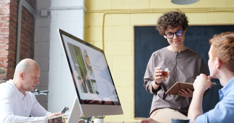 man-in-blue-collared-top-using-imac-indoors