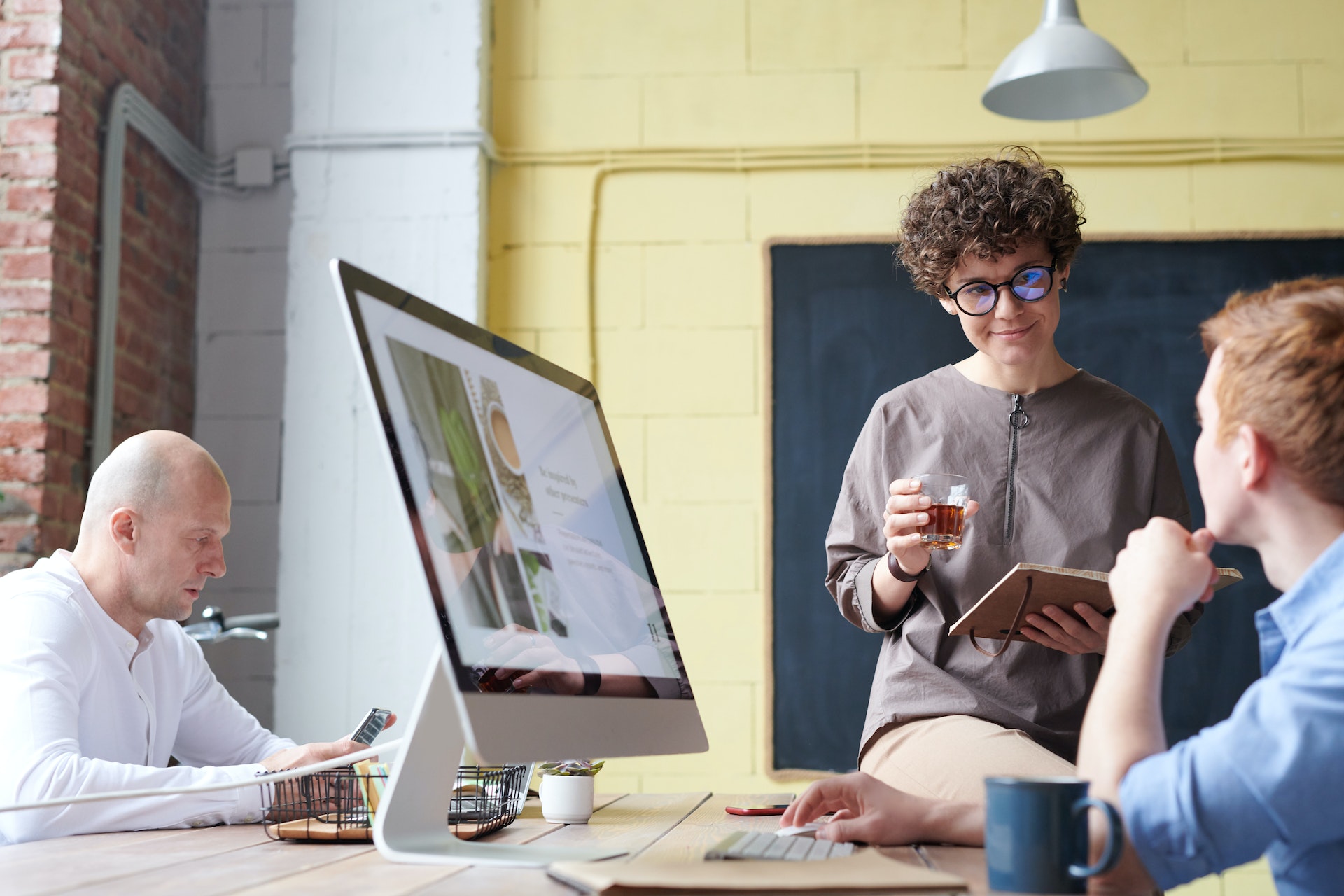 man-in-blue-collared-top-using-imac-indoors
